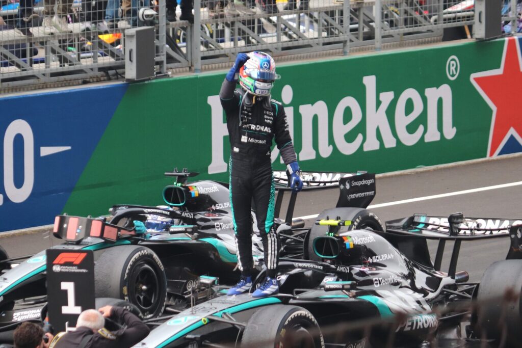 Kimi Antonelli celebrates with the Mercedes F1 team after a podium finish