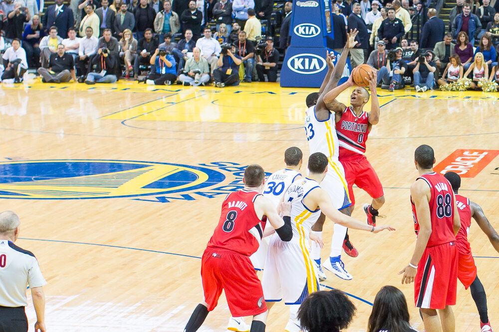 Draymond Green defending against the Portland Trail Blazers at a Golden State Warriors home game