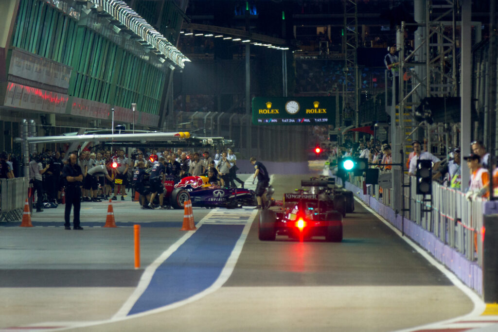 An empty Formula 1 pit lane with team garages during a race weekend, photographed at a previous Grand Prix