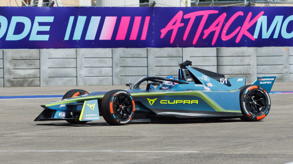 A Formula E Gen3 race car driven by Kelvin van der Linde competes on the Tempelhof Airport Street Circuit during the 2024 Berlin E-Prix.