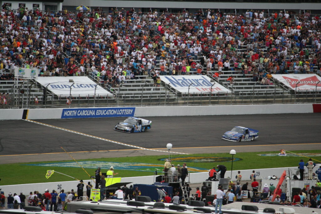 Kyle Larson race car in action on a NASCAR oval track