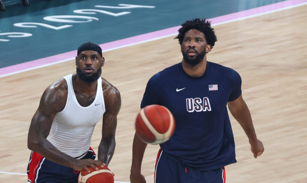 LeBron James and Joel Embiid standing together on the court during the 2024 Paris Olympics.
