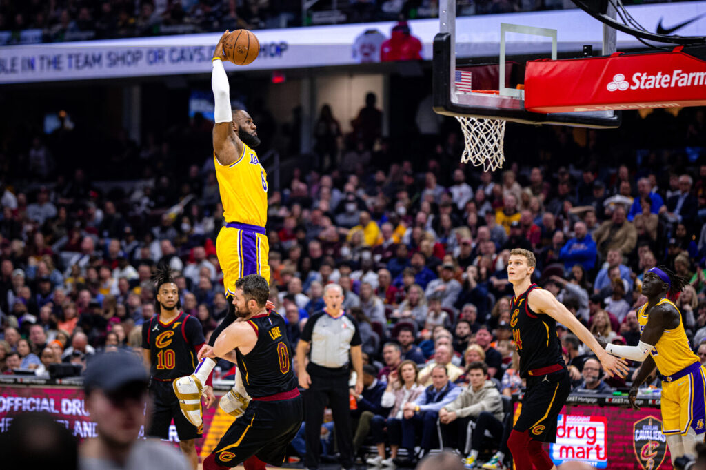 LeBron James driving to the basket in a Lakers uniform during an NBA game