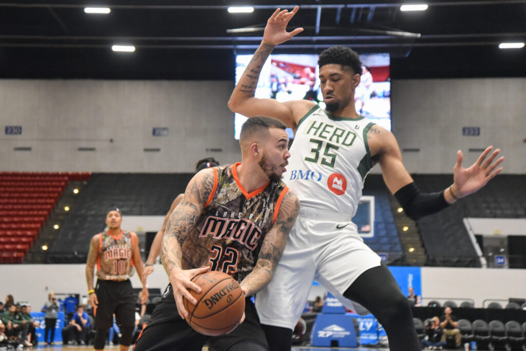 Two players battle for position in the paint during an NBA G League game between the Lakeland Magic and Wisconsin Herd.