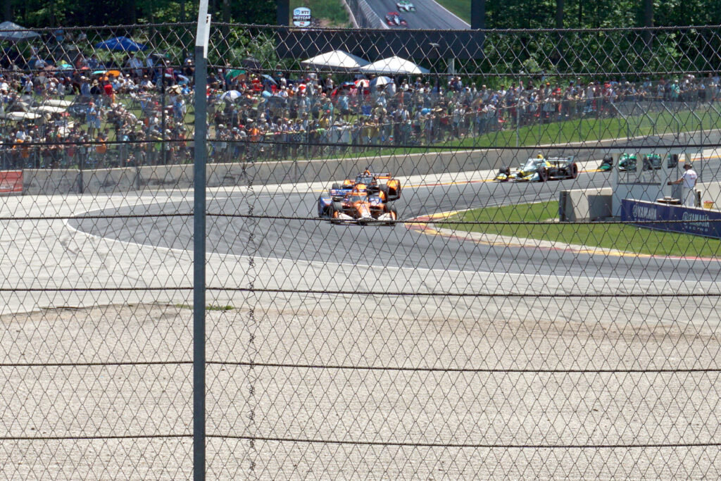 An Arrow McLaren IndyCar races through a corner during an NTT IndyCar Series road course event