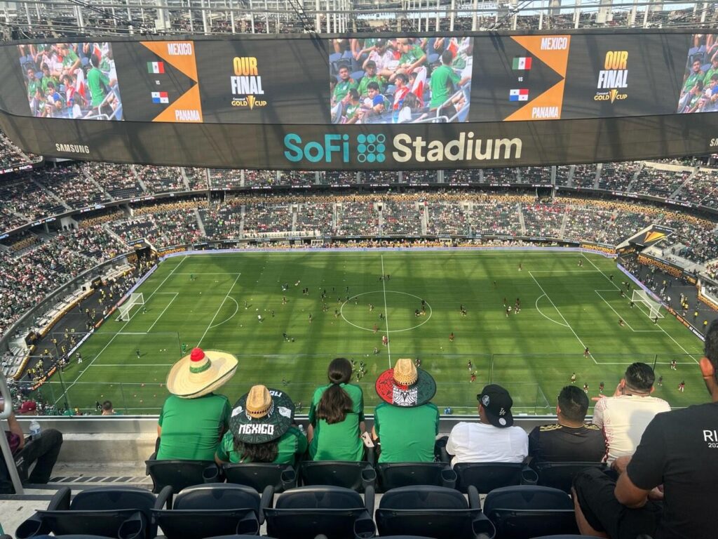 A packed SoFi Stadium crowd watches a 2023 CONCACAF Gold Cup final match between Mexico and Panama.