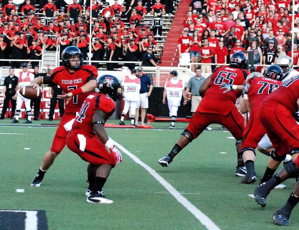 Texas Tech quarterback dropping back to pass during a game at the Red Raiders football stadium