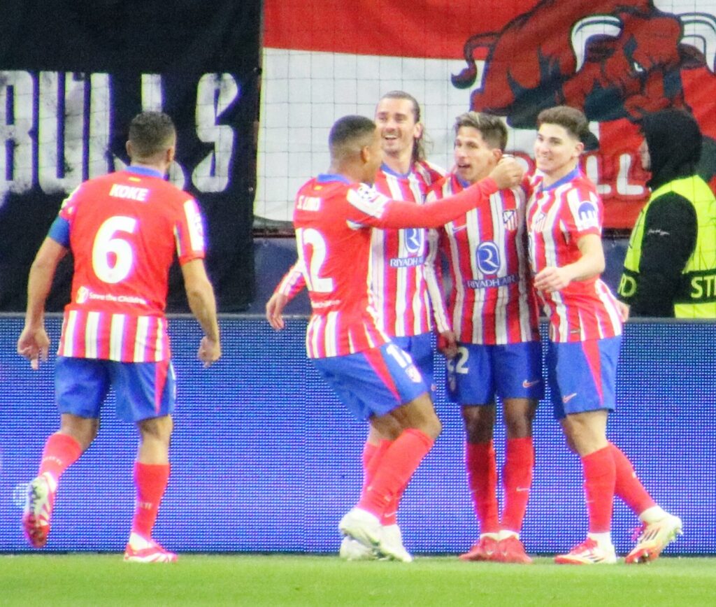 Atletico Madrid players, including Julian Alvarez and Antoine Griezmann, celebrate a goal during a UEFA Champions League match against FC Salzburg, January 2025