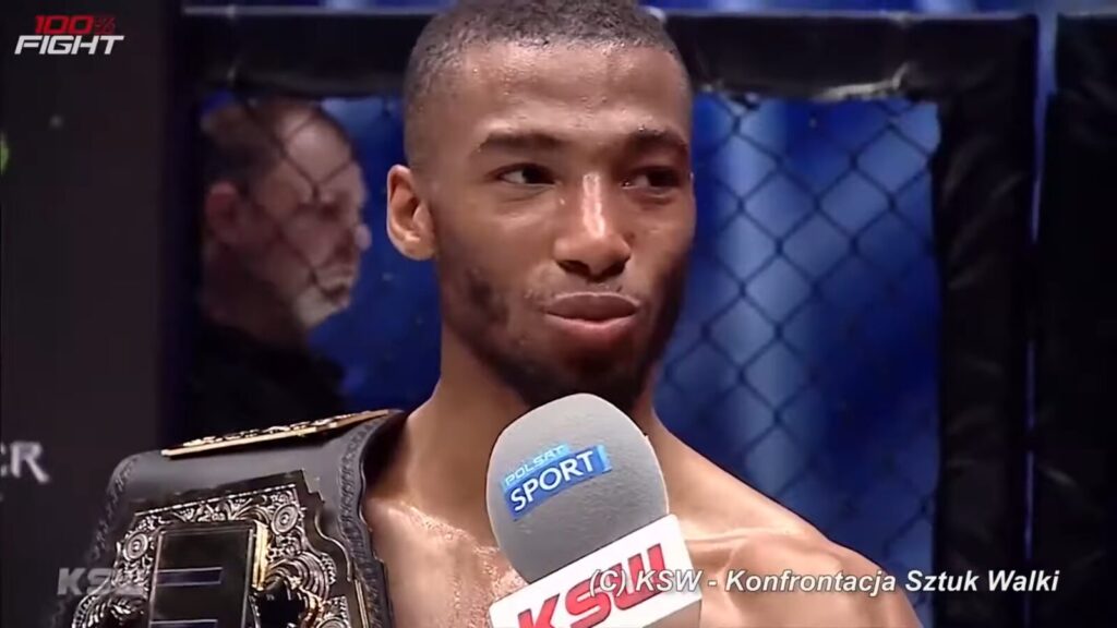 Salahdine Parnasse, close-up, sweaty and shirtless with a KSW championship belt over his shoulder, being interviewed at a KSW cage event. (File photo: Salahdine Parnasse after a KSW title fight, 2021, not from UFC Paris.) (File photo: Salahdine Parnasse after a KSW title fight, 2021, not from UFC Paris.)