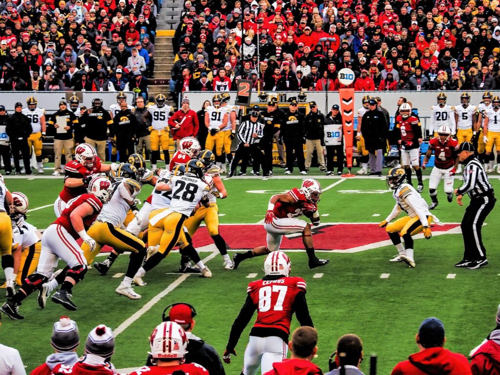 Jonathan Taylor (No. 23) breaking through the line during a college football game at Wisconsin