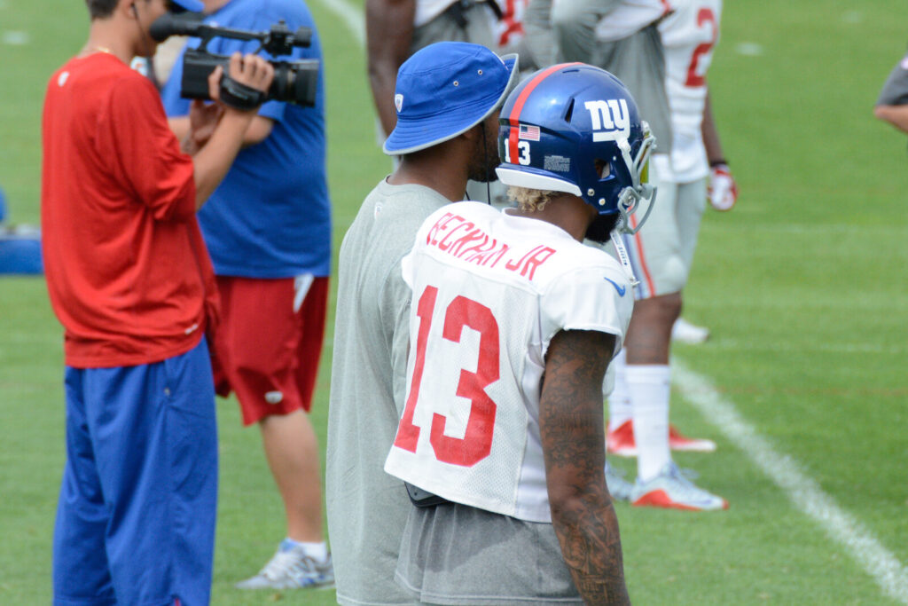 NFL players on the field during a training camp practice open to fans