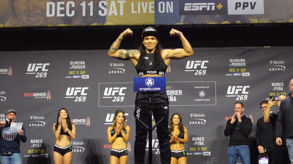 Amanda Nunes and Julianna Pena face off on stage during a UFC ceremonial weigh-in